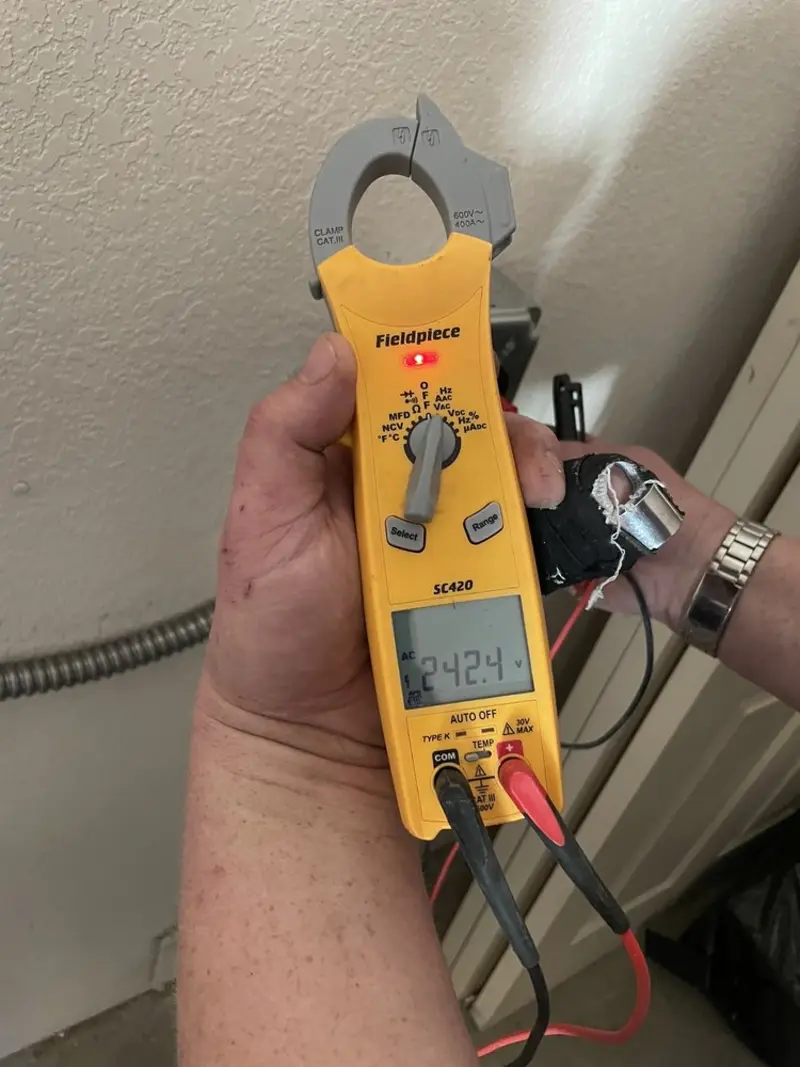 Voltage testing with clamp meter during Recessed Lighting Installation in Madison